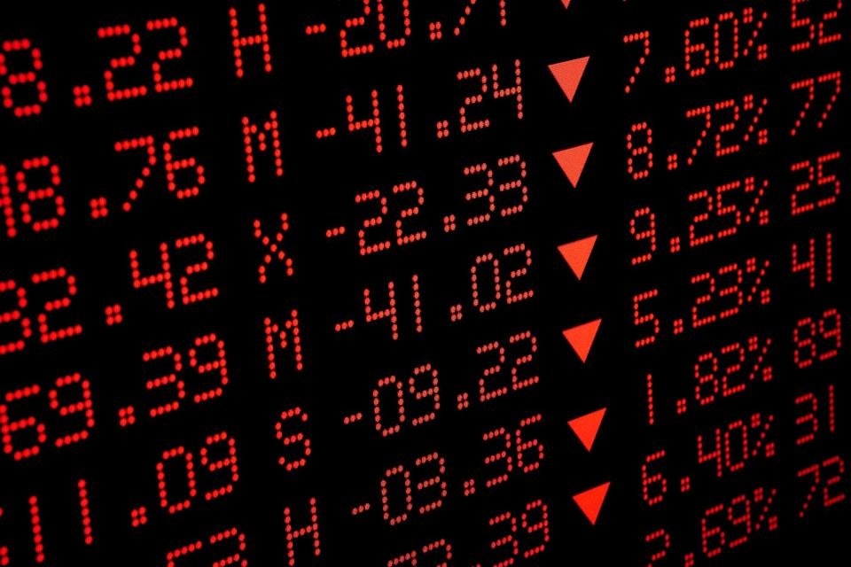 A digital display is showing many declining stock prices. 